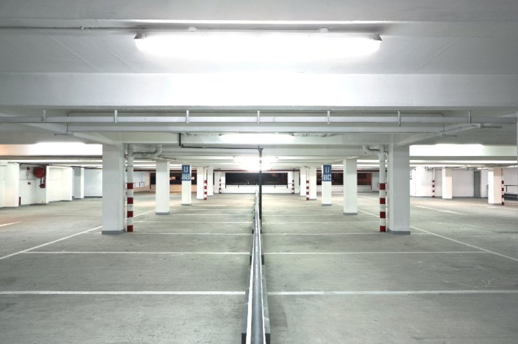 Parking garage with freshly marked stalls and lane lines, showing clear striping for organized parking and traffic flow.